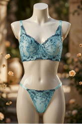 Mannequin wearing a blue lace bra and thong set with a blurred floral background