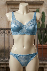 Mannequin wearing a blue lace lingerie set with a blurred background