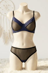 Mannequin wearing a navy blue bra and black underwear on a white background