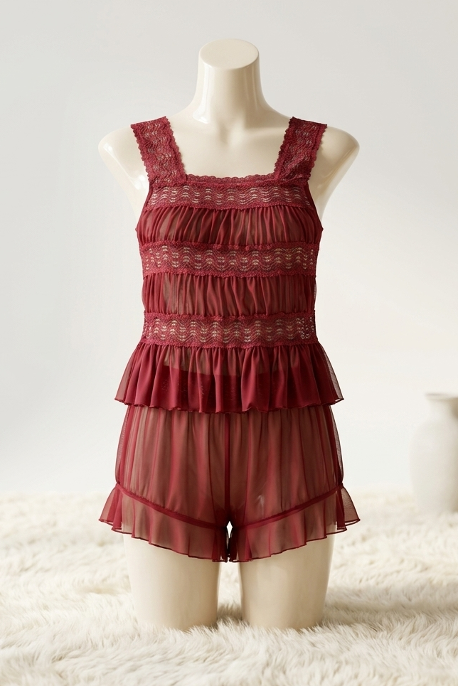 Red lace romper on a mannequin against a white background