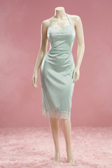 Light blue dress on a mannequin against a pink background