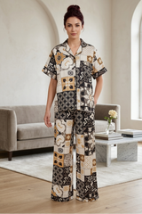 Woman wearing a patterned outfit in a modern living room.