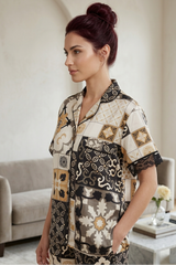 Woman wearing a patterned outfit in a living room setting