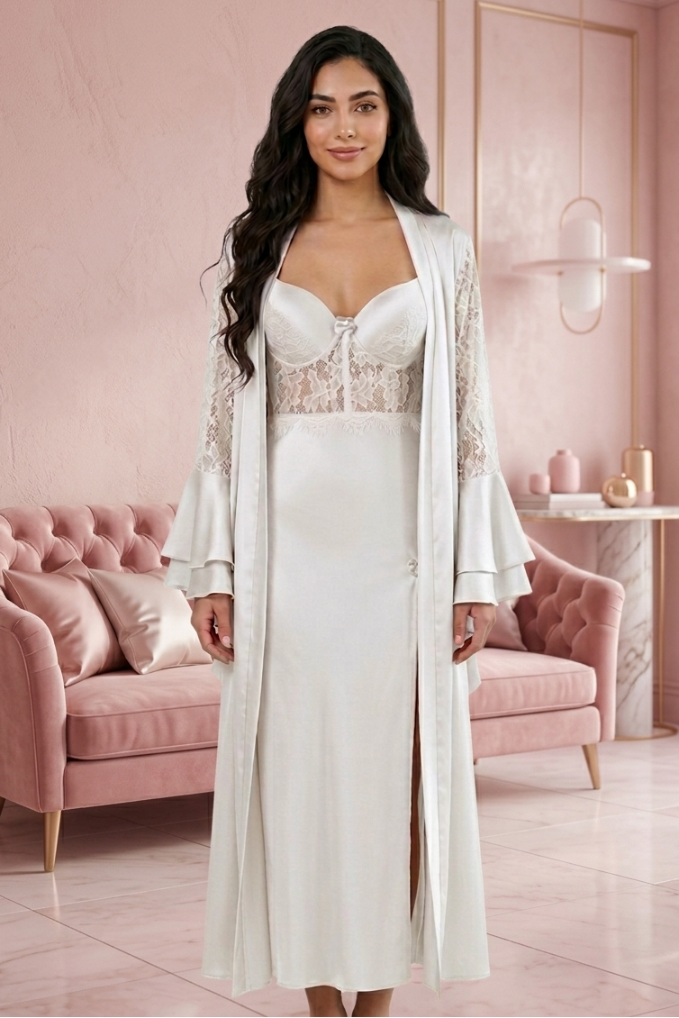 Woman in a white lace dress with a matching long jacket in a pink room.