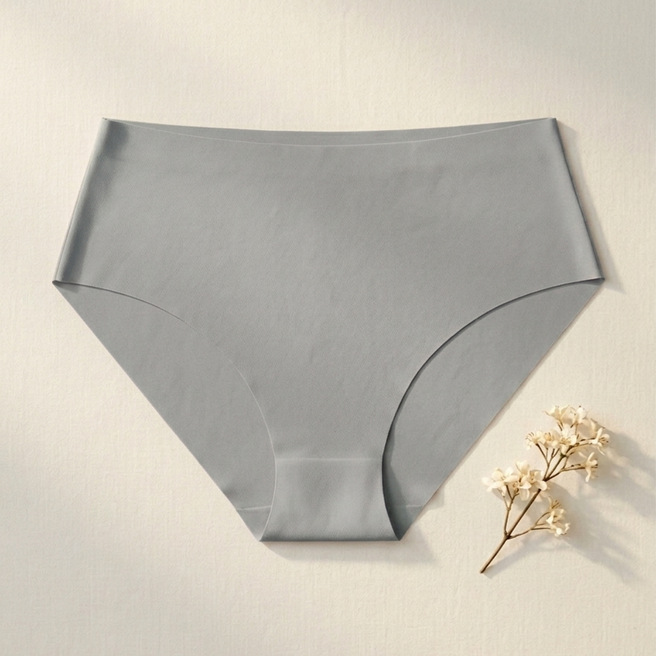Gray underwear on a light beige background with a small plant.