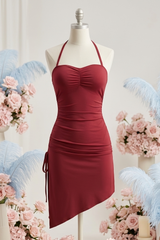 Red dress on a mannequin with floral decorations and candles in the background