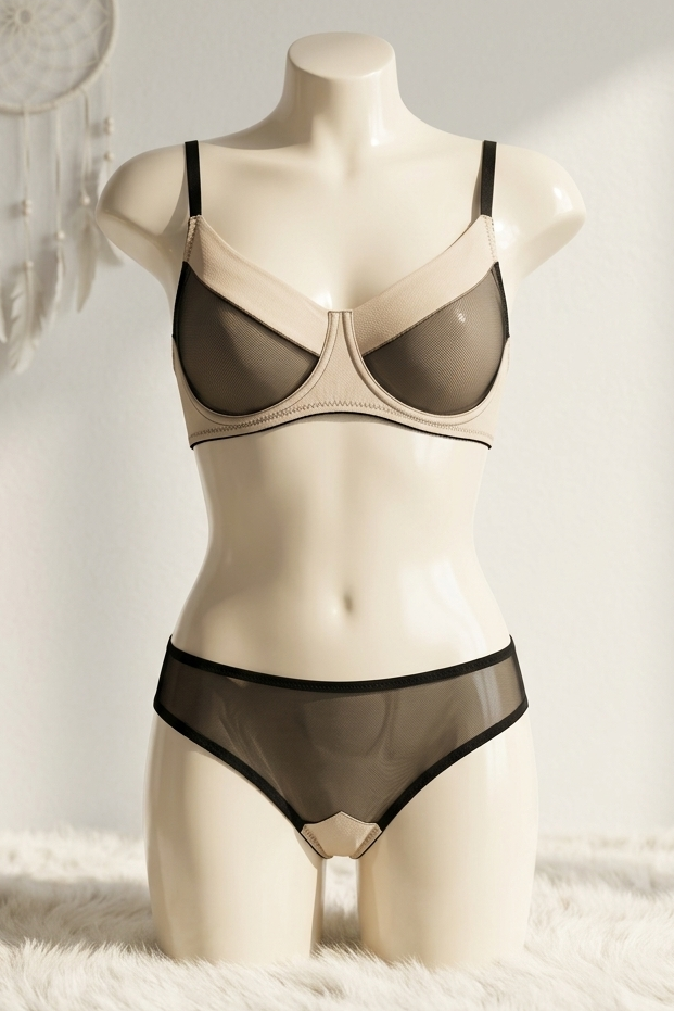 Mannequin wearing a black bra and panties set on a white surface with a dreamcatcher in the background.